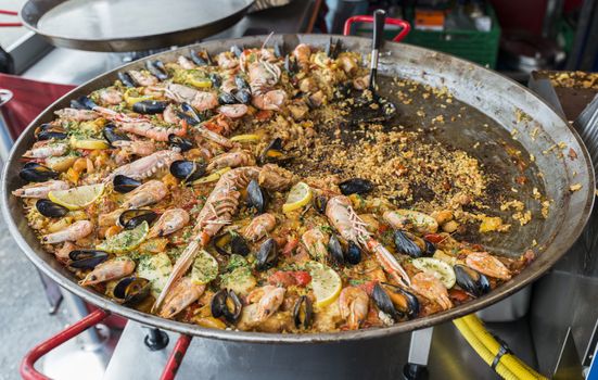 big pan with fish paella food on heating fire for tourists to buy and eat in Bergen Norway