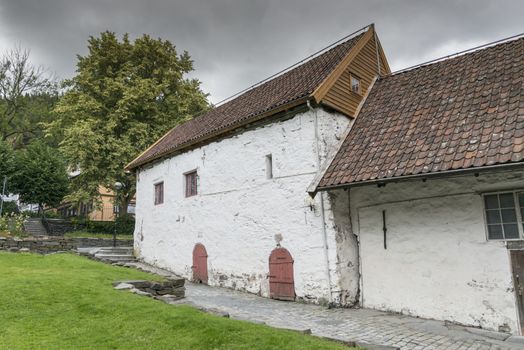 very old concrete white house build in 1666  in the village of bergen in Norway
