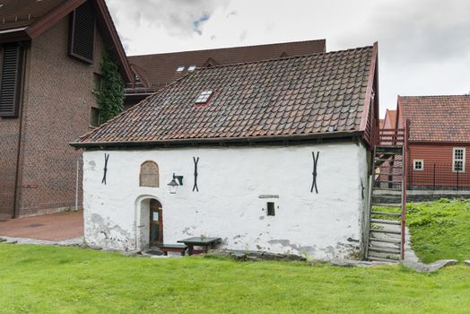very old concrete white house build in 1666  in the village of bergen in Norway