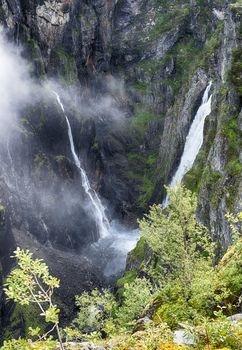 Voringfossen waterfall in norway seen from street level on sunny day 