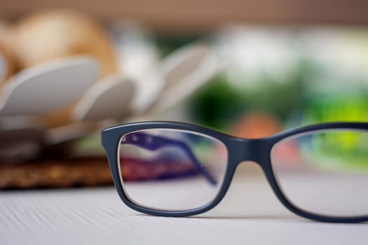 a pair of eyeglasses on a white plane