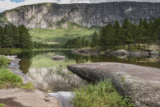 national park in norway with reflection of mountains in the water pond