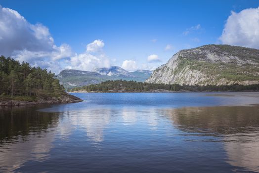 reflections of the mountains as a mirror in the fjord in norway near valle