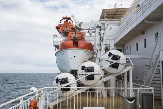 orange and white lifeboat on a cruide ship on the sea