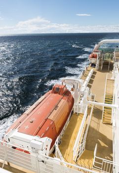 orange and white lifeboat on a cruise ship on the sea