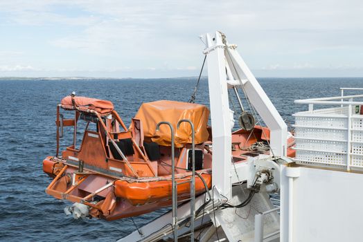 orange and white lifeboat on a cruise ship on the sea
