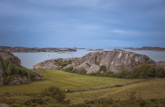 coastline in sweden above fjallbacka with boats and sea as background