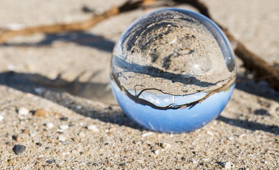 glass sphere with hellevoetsluis lighthouse from the beach