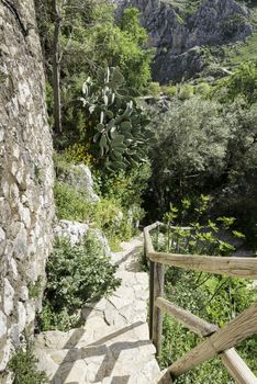 walking path with stairs made from rocks in the andalusia city of Zuheros near the castle