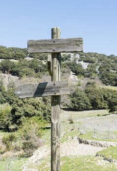 wooden pole with destination to east and west