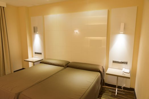 modern hotel room with bed and pillows 