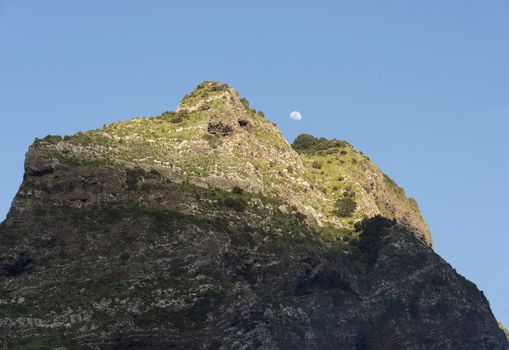 mounatain peakes on Madeira with blue sky and moon as background