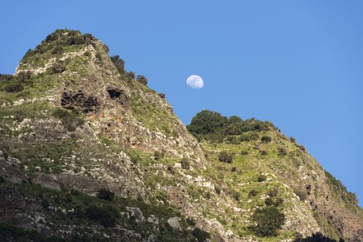 mounatain peakes on Madeira with blue sky and moon as background