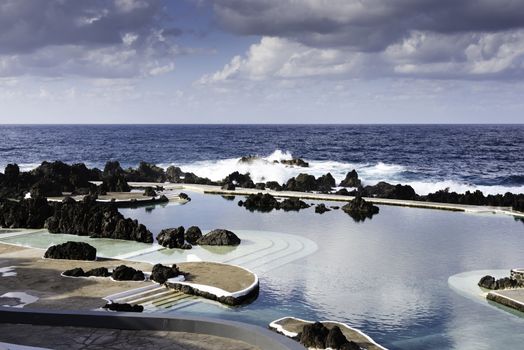 Natural pools in Porto Moniz with lava rocks and atlantic ocean as background on Madeira, Portugal