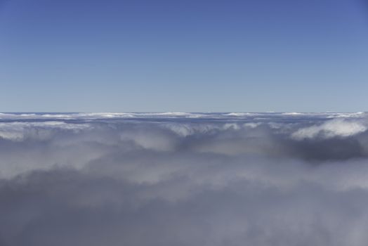 blue sky and clouds on the horizon from airplane view
