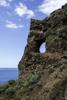 rock on the eastcoast of madeira near Calheta with hola and view to the blue sky