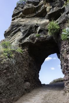 rock on the eastcoast of madeira near Calheta with hole and view to the blue sky