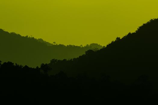view of forest in thailand and  sky is many colour at sunset .