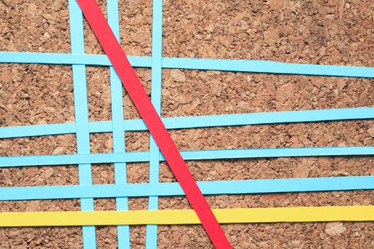 Lot of color paper lines in a row on wooden background