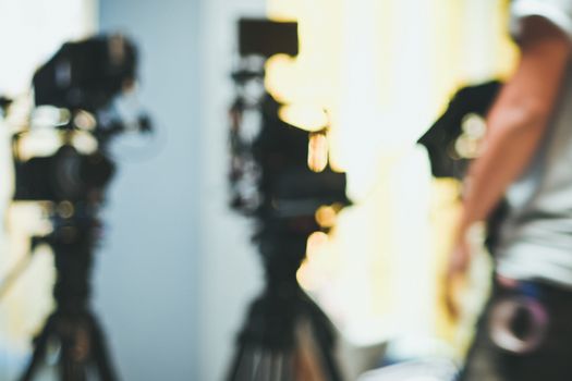 Abstract blurred background of video camera shooting in studio, recording movie production
