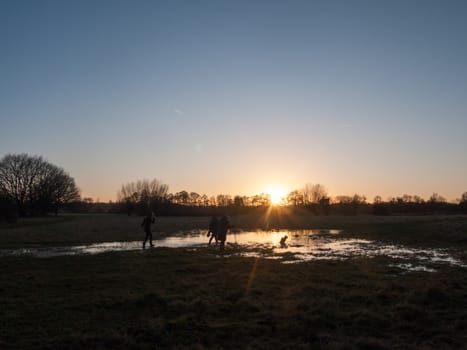 sunset waterlogged country walkway white sky autumn field dedham people; essex; england; uk
