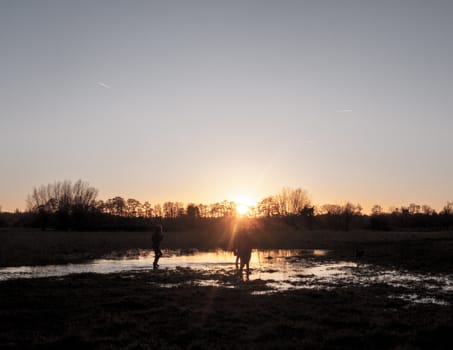sunset waterlogged country walkway white sky autumn field dedham people; essex; england; uk