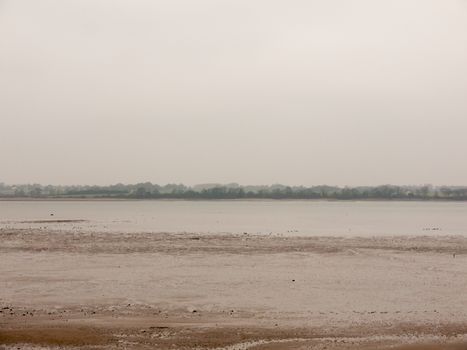 beach coastal shoreline grey overcast sky bleak depressing; essex; england; uk