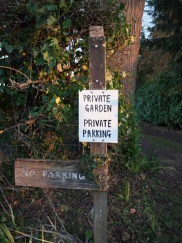 black and white private garden private parking sign; essex; england; uk