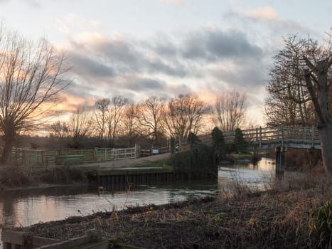 flatford mill river bridge crossing nature sunset autumn winter sky; essex; england; uk