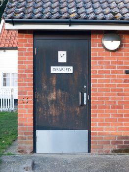 disabled black toilet door outside public park; essex; england; uk