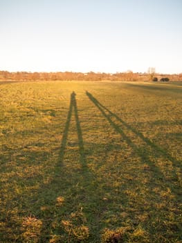 two large leg silhouettes on grass land background surface; essex; england; uk