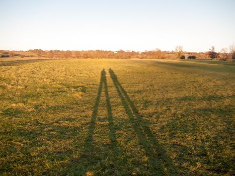 two large leg silhouettes on grass land background surface; essex; england; uk