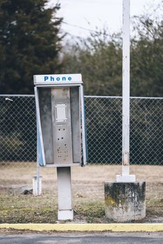 Abandoned payphone box. Phone is missing.