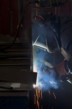 Welder worker and bright sparks 