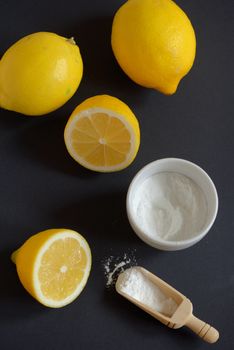 Sodium bicarbonate and lemon on black background