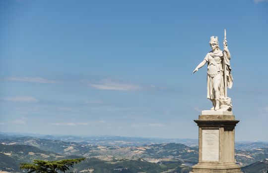 view of the ancient statue of liberty against the bright blue sky in San Marino Republic