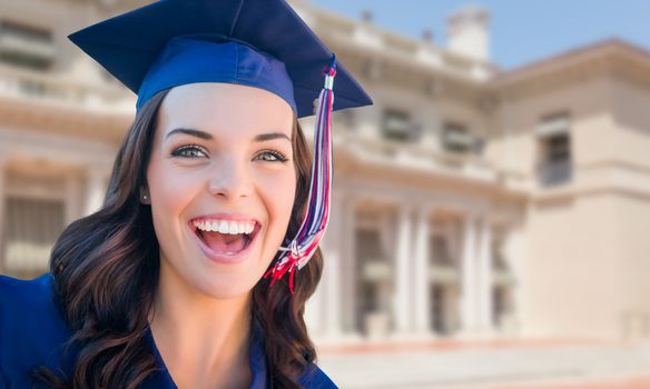 Happy Graduating Mixed Race Woman In Cap and Gown Celebrating on Campus.