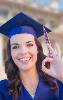 Happy Graduating Mixed Race Woman In Cap and Gown Celebrating on Campus.