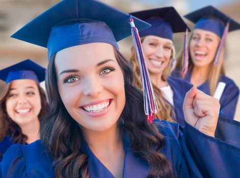 Happy Graduating Group of Girls In Cap and Gown Celebrating on Campus.