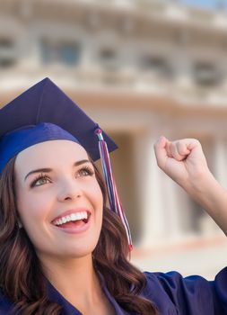 Happy Graduating Mixed Race Woman In Cap and Gown Celebrating on Campus.