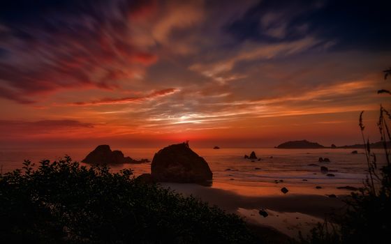 This is a color landscape photo of a vivid sunset over the Pacific Ocean.