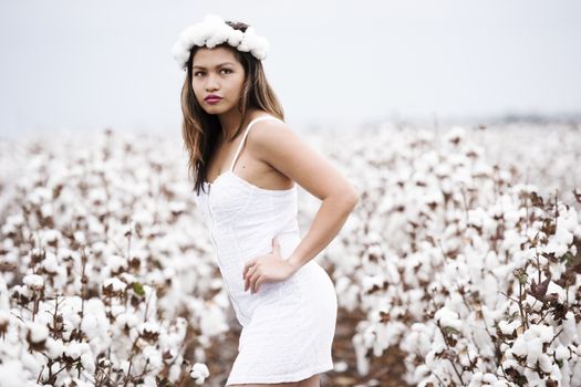 Young woman in a field of cotton in Oakey, Queensland