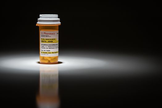 Hydrocodone Pills and Prescription Bottle with Non Proprietary Label. No model release required - contains ficticious information.