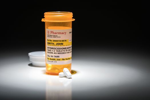 Hydrocodone Pills and Prescription Bottle with Non Proprietary Label. No model release required - contains ficticious information.