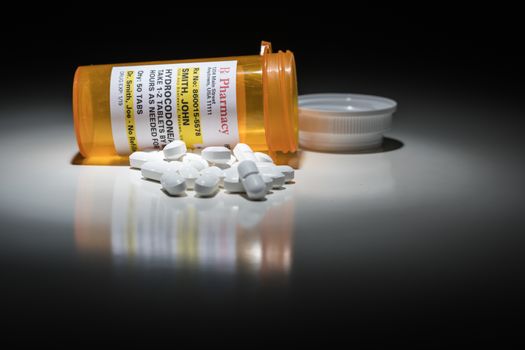 Hydrocodone Pills and Prescription Bottle with Non Proprietary Label. No model release required - contains ficticious information.