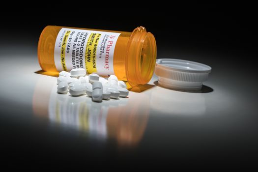 Hydrocodone Pills and Prescription Bottle with Non Proprietary Label. No model release required - contains ficticious information.