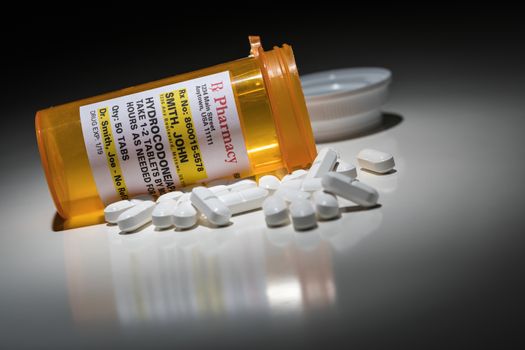 Hydrocodone Pills and Prescription Bottle with Non Proprietary Label. No model release required - contains ficticious information.