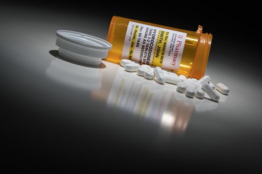 Hydrocodone Pills and Prescription Bottle with Non Proprietary Label. No model release required - contains ficticious information.