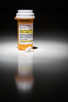 Hydrocodone Pills and Prescription Bottle with Non Proprietary Label. No model release required - contains ficticious information.