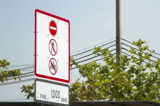 Do not walk and do not ride a motorcyclewarning sign against blue sky